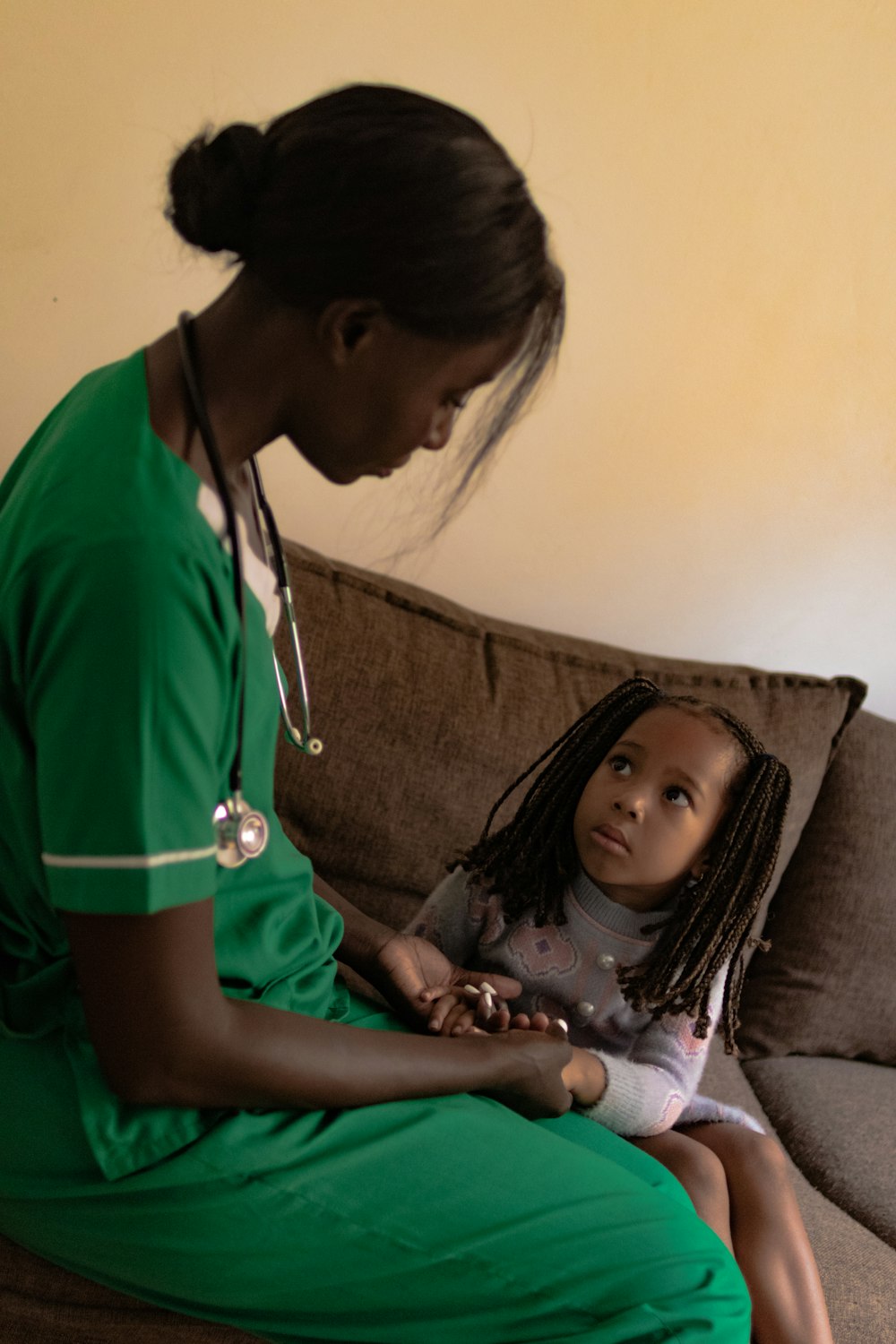 Nurse comforting a young child