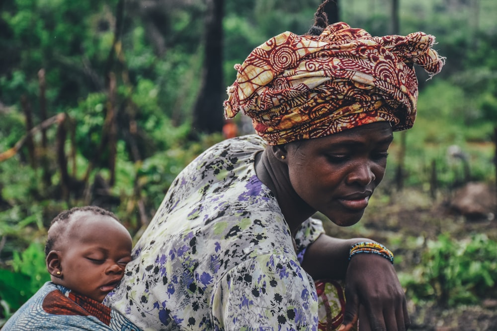 Mother carrying her baby, East Africa