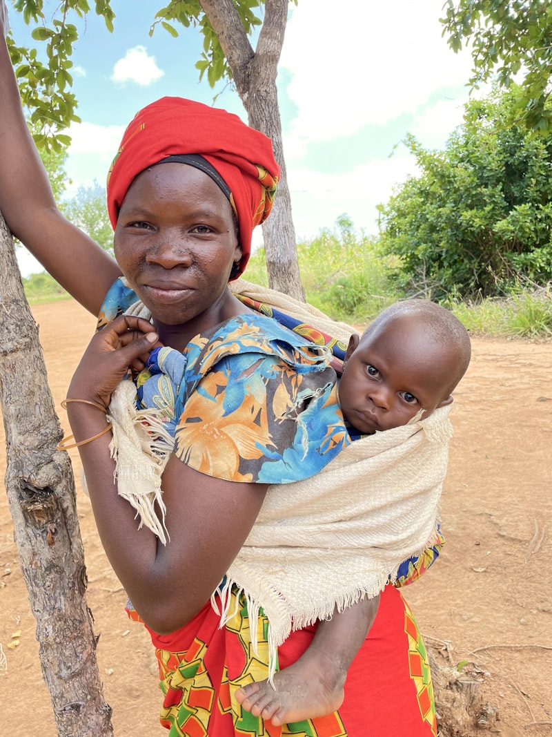Community health worker holding a baby
