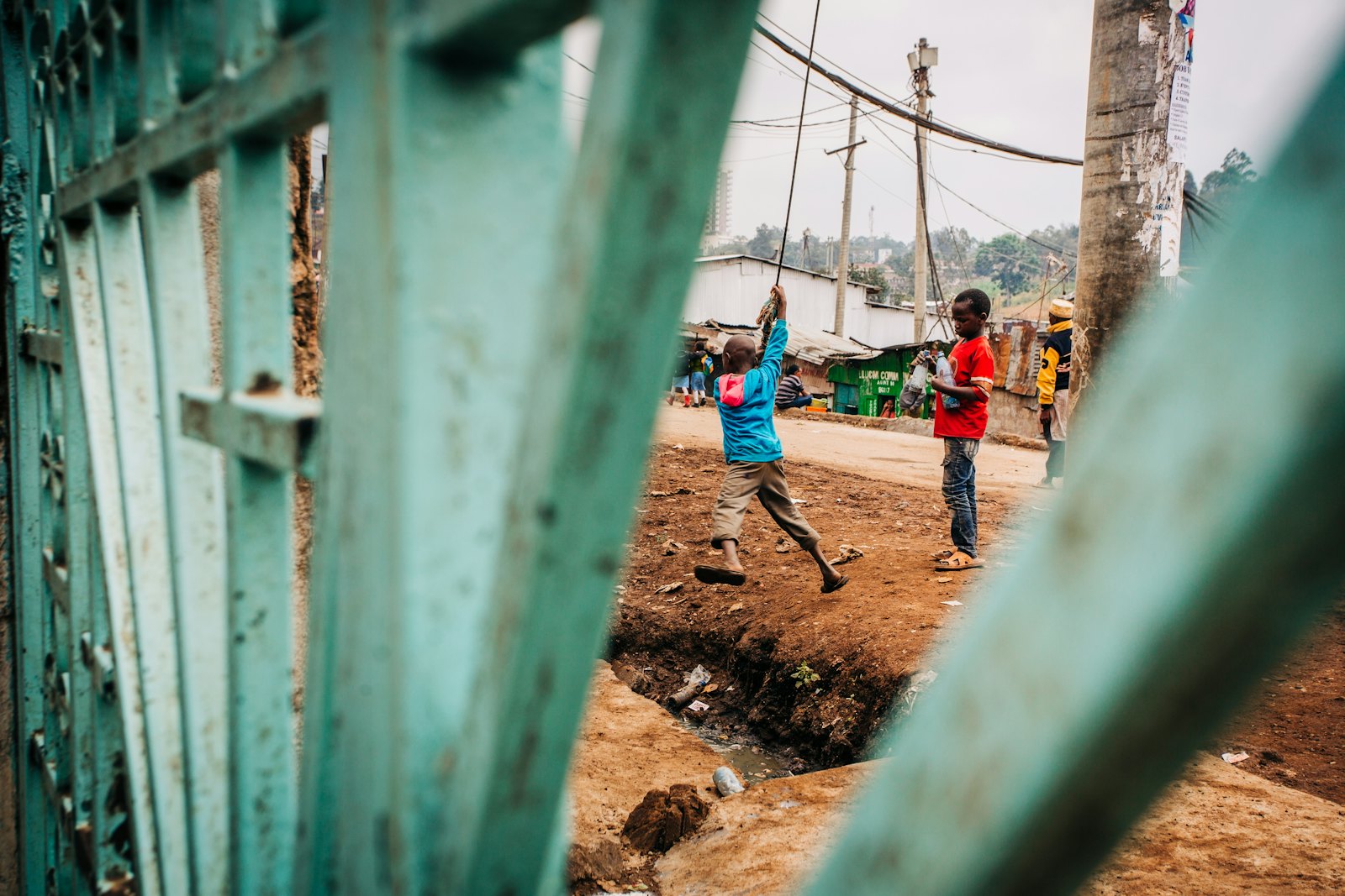 Children playing by a gate in Kenya